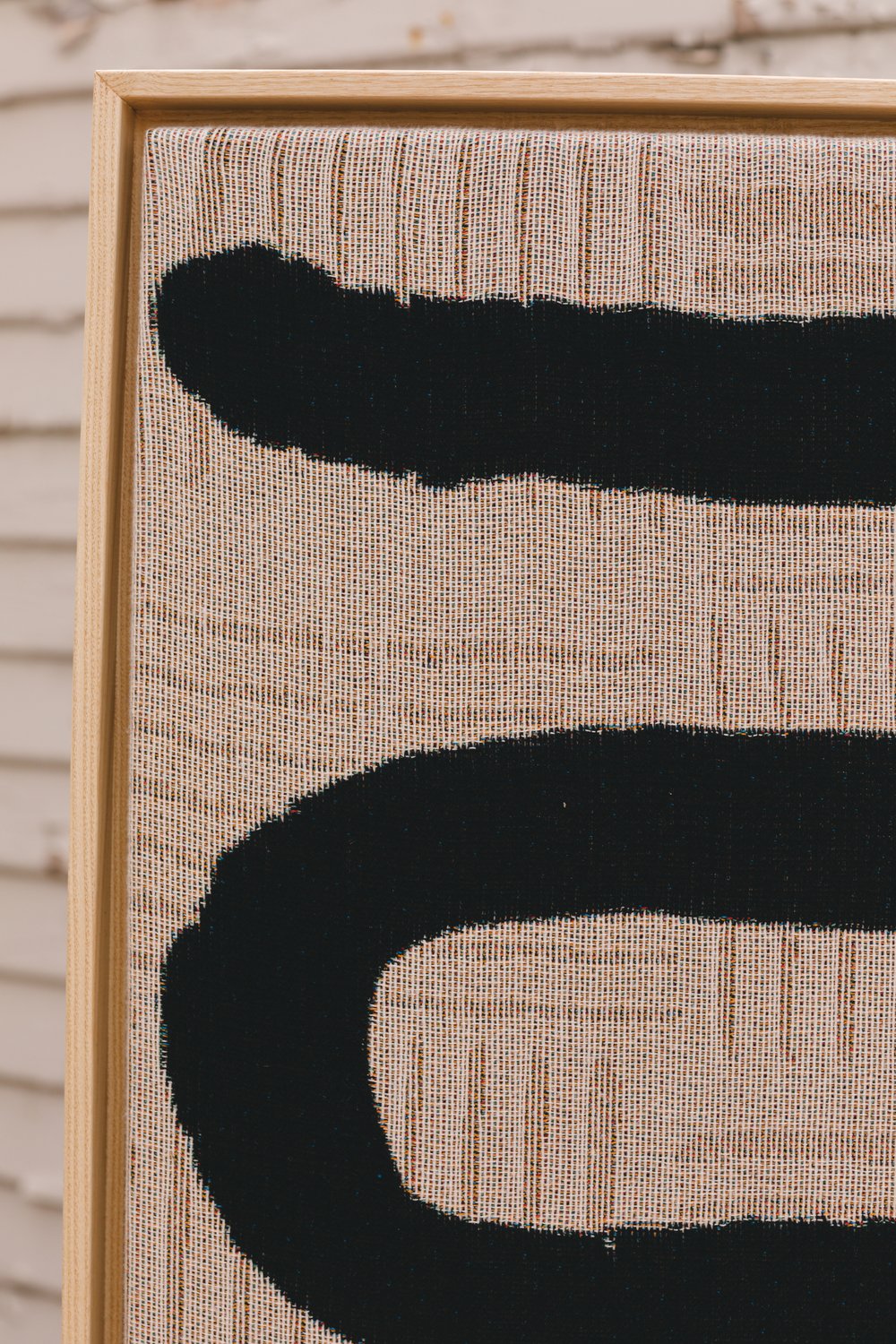 Organic linework in woven art styled on neutral-toned furniture